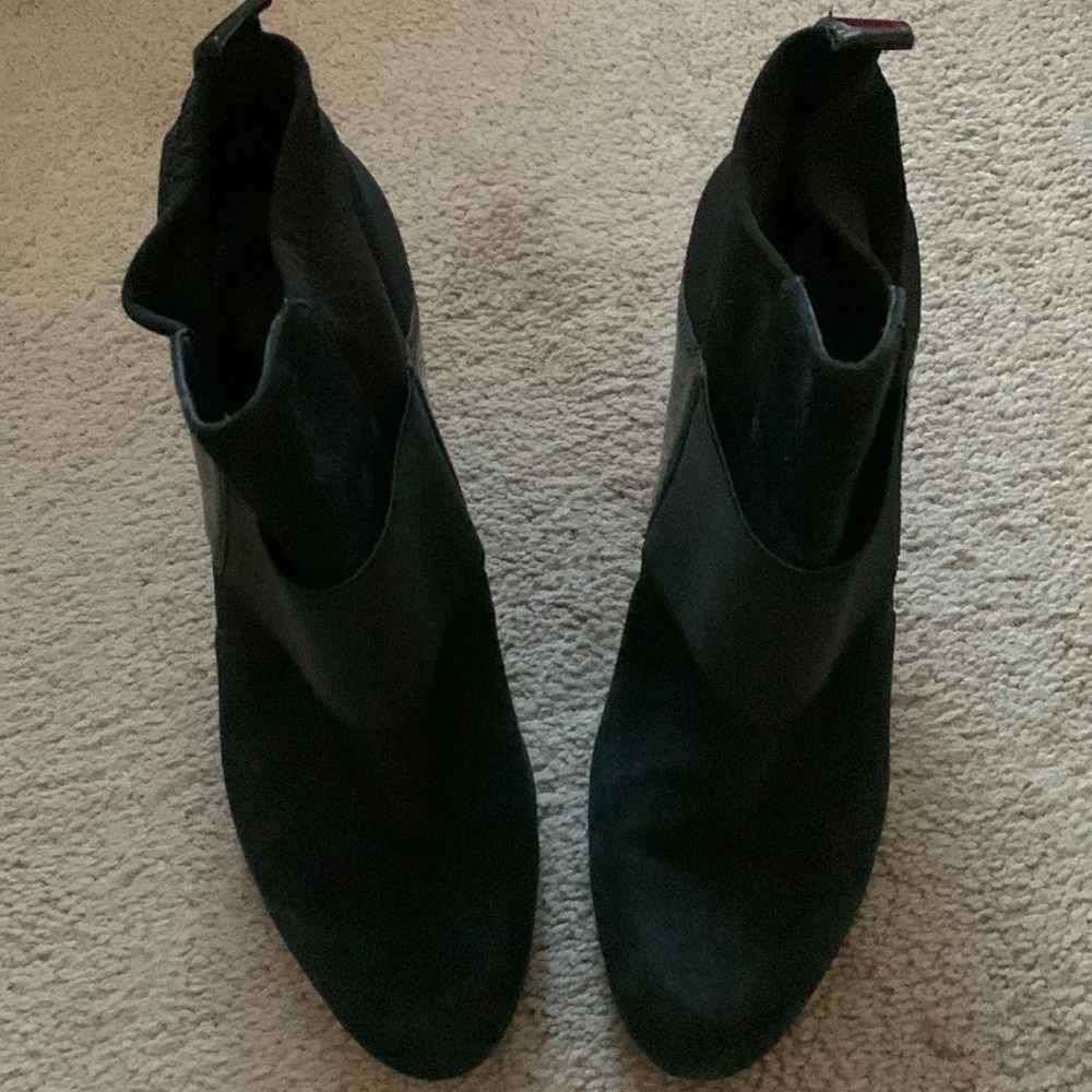 Cute black suede booties with a stretch and paten leather strap across front.